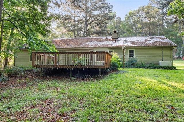 1757 Mystery Cir SW, Conyers, GA 30094 - rear view of house with a wooden deck, a lawn, and a chimney