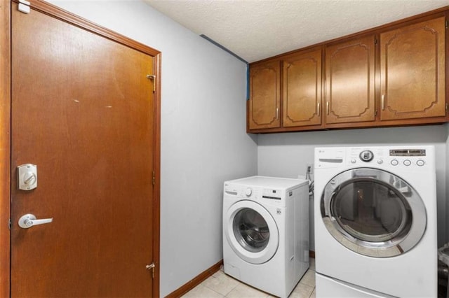 1757 Mystery Cir SW, Conyers, GA 30094 - laundry room featuring cabinet space, washer and dryer, light tile patterned flooring, a textured ceiling, and baseboards
