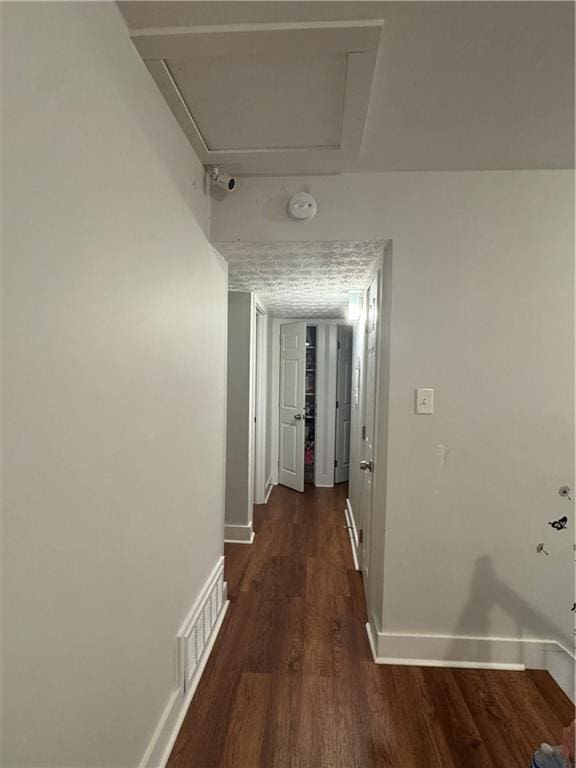 corridor with dark hardwood / wood-style floors