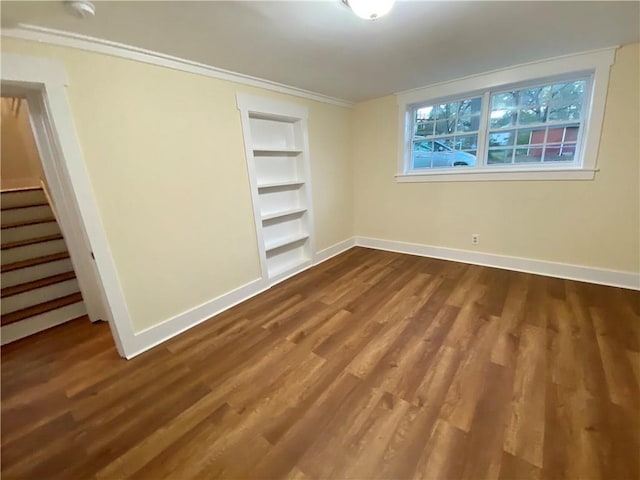 unfurnished bedroom featuring a closet, hardwood / wood-style floors, and ornamental molding