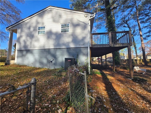 view of side of home featuring a wooden deck and central AC unit