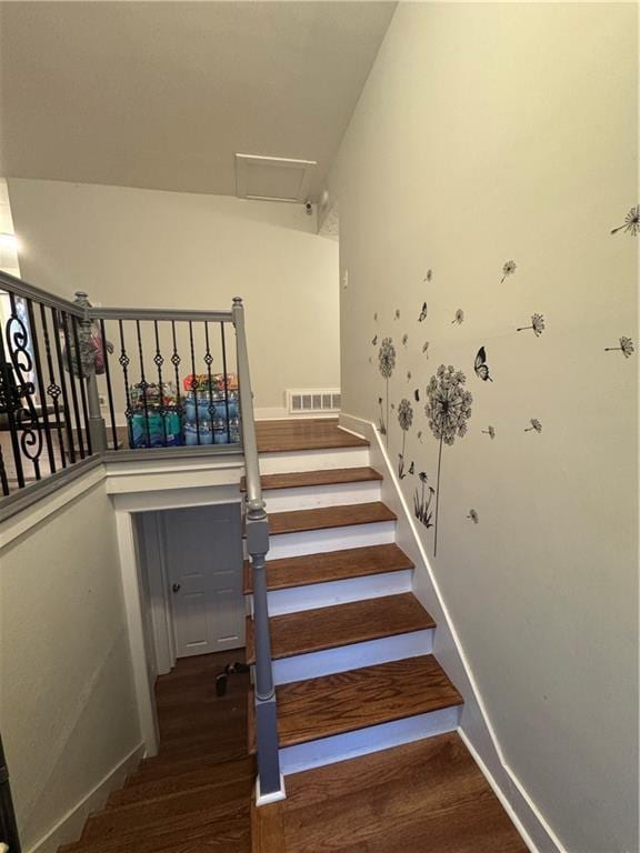 staircase with hardwood / wood-style floors