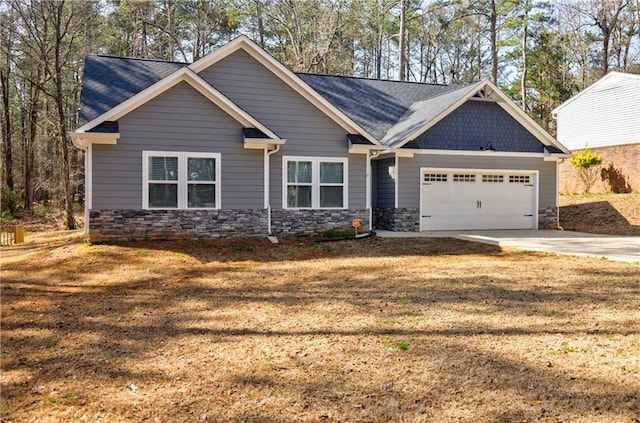 craftsman house with stone siding, driveway, a front yard, and a garage