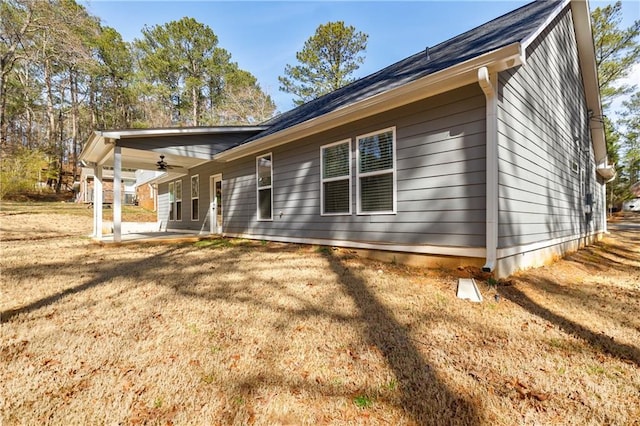 back of house with a yard, a patio, and a ceiling fan