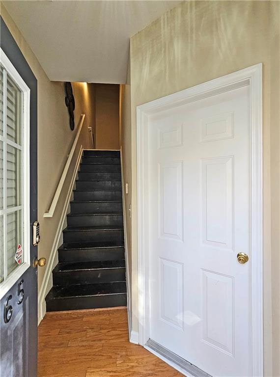 stairs featuring hardwood / wood-style flooring