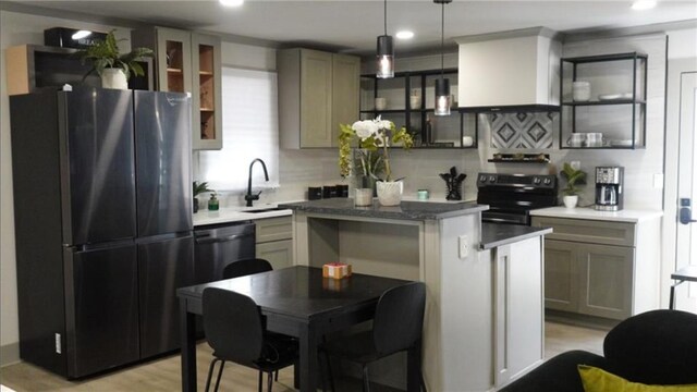 kitchen with a sink, appliances with stainless steel finishes, custom exhaust hood, decorative light fixtures, and decorative backsplash