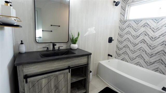full bath with tub / shower combination, tile patterned floors, and vanity