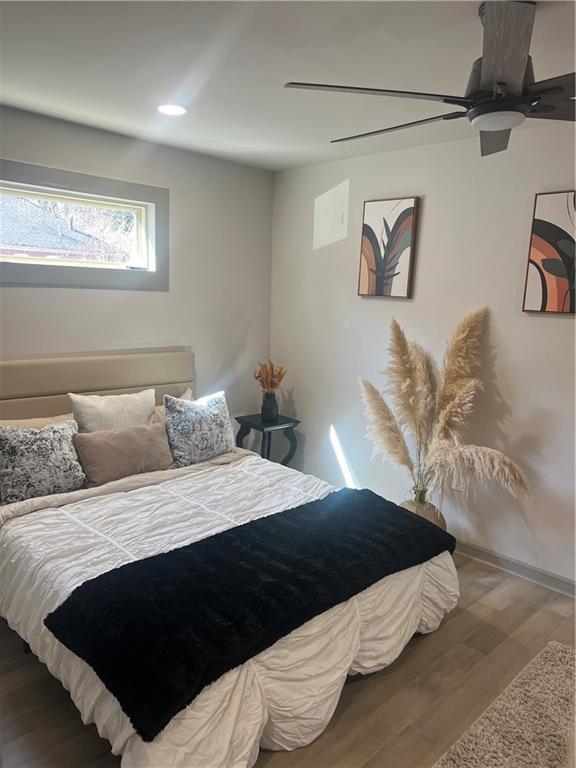 bedroom featuring wood finished floors, ceiling fan, and recessed lighting