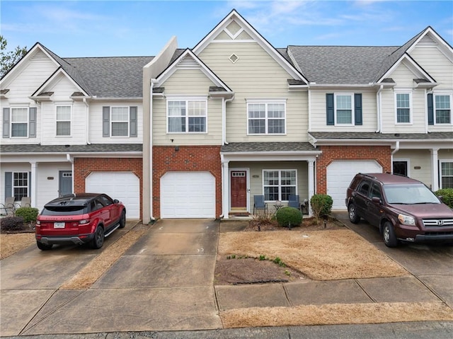 townhome / multi-family property featuring brick siding, an attached garage, roof with shingles, and driveway