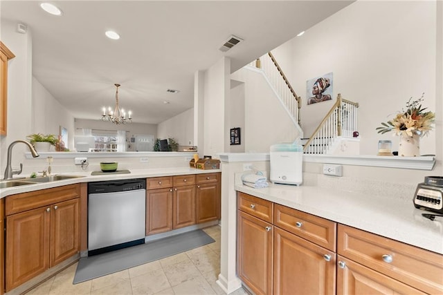 kitchen with visible vents, light countertops, brown cabinets, stainless steel dishwasher, and a sink