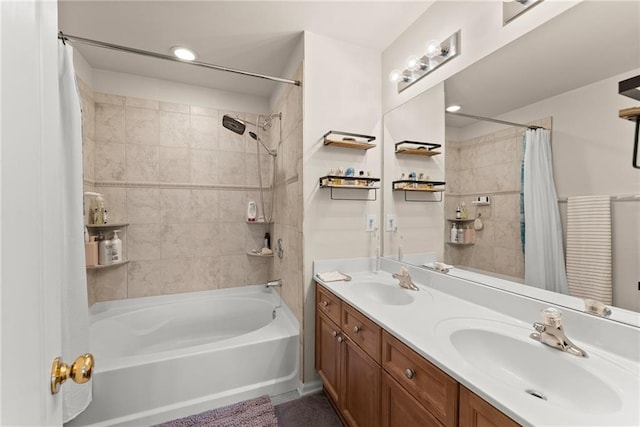 bathroom featuring double vanity, shower / bath combo with shower curtain, and a sink