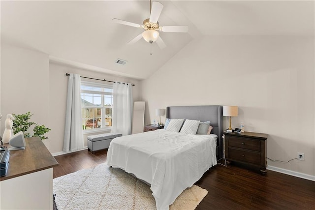 bedroom featuring lofted ceiling, baseboards, visible vents, and wood-type flooring