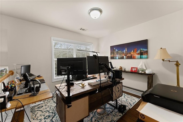 office featuring visible vents and wood finished floors