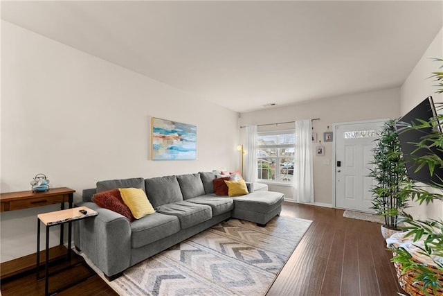 living area with hardwood / wood-style floors and baseboards