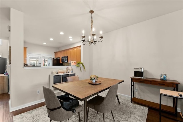 dining room with recessed lighting, baseboards, and wood finished floors