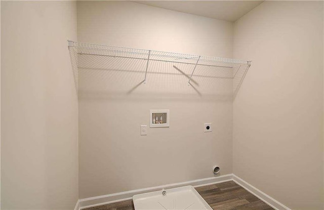 washroom featuring electric dryer hookup, hookup for a washing machine, and dark hardwood / wood-style flooring