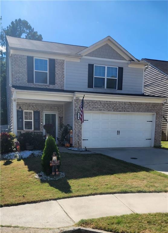 view of front facade with a front yard and a garage