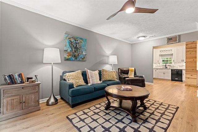 living room with sink, ceiling fan, light hardwood / wood-style floors, and crown molding