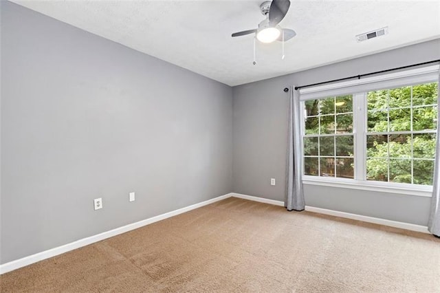 carpeted empty room with ceiling fan