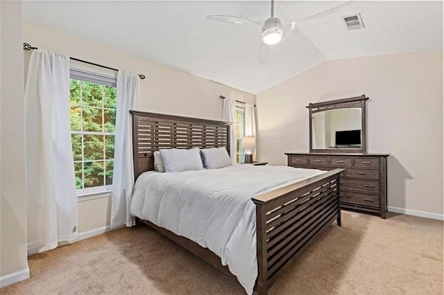 bedroom with lofted ceiling, multiple windows, light carpet, and ceiling fan