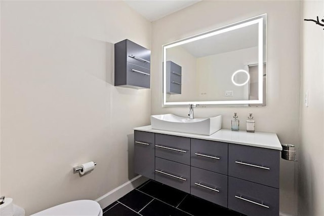 bathroom with tile patterned flooring, vanity, and toilet