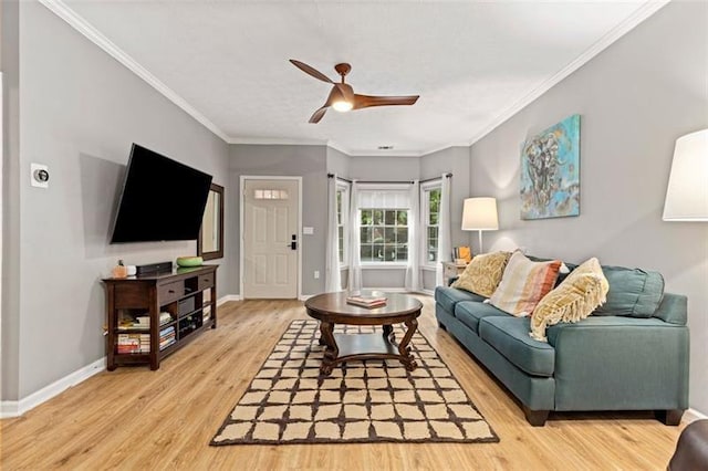 living room featuring ceiling fan, ornamental molding, and hardwood / wood-style flooring