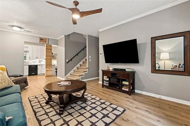 living room featuring ornamental molding, ceiling fan, and light hardwood / wood-style flooring