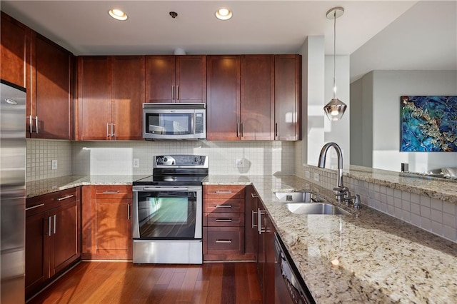 kitchen featuring dark wood-type flooring, a sink, tasteful backsplash, stainless steel appliances, and dark brown cabinets