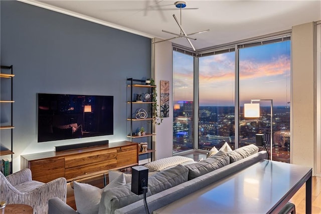 living area featuring a wall of windows, ornamental molding, wood finished floors, and a chandelier