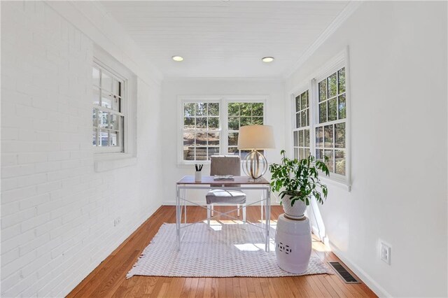 living room featuring beam ceiling and hardwood / wood-style floors