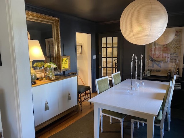 dining room with crown molding and dark hardwood / wood-style floors