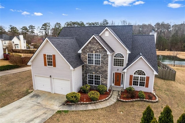 traditional-style house with a chimney, a shingled roof, an attached garage, stone siding, and driveway