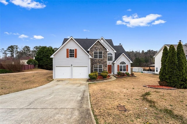 traditional home with driveway, a garage, stone siding, fence, and a front lawn