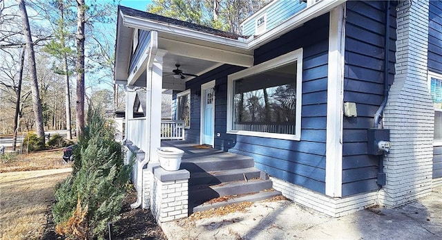 doorway to property with ceiling fan and a porch