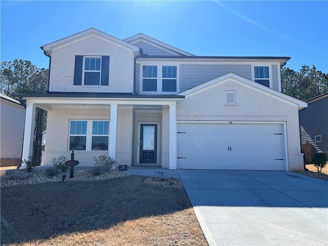 view of front of property featuring driveway, covered porch, and a garage