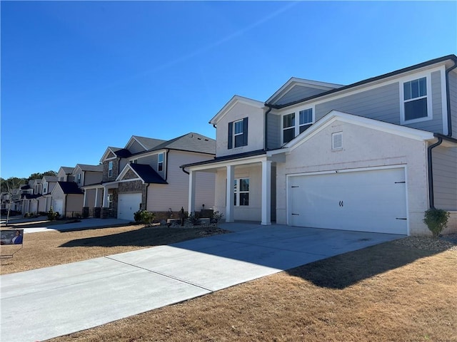 view of front of property featuring a garage, a residential view, and driveway