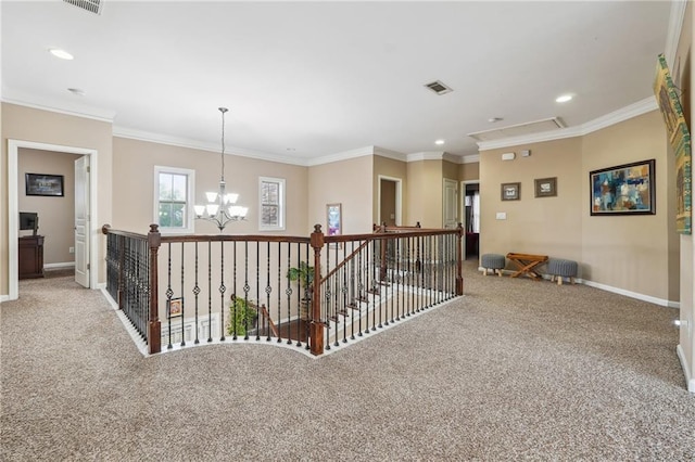 hallway featuring attic access, carpet, baseboards, and ornamental molding