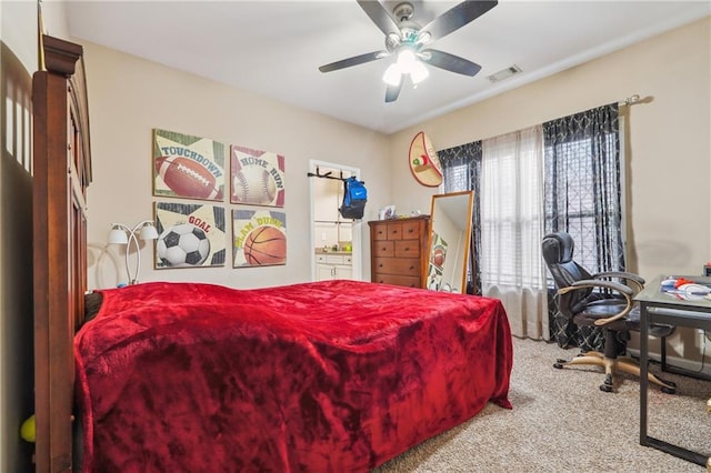 bedroom featuring connected bathroom, visible vents, carpet, and ceiling fan