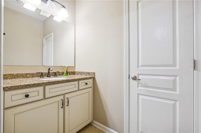 bathroom featuring vanity and baseboards