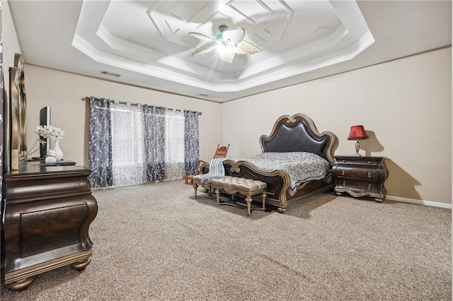 carpeted bedroom featuring a ceiling fan, baseboards, visible vents, ornamental molding, and a raised ceiling