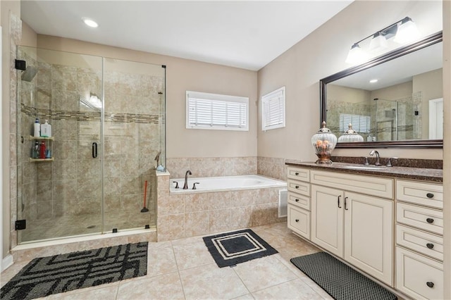 full bath featuring tile patterned flooring, a stall shower, a bath, and vanity