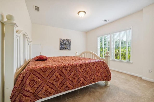 bedroom featuring visible vents, baseboards, and carpet floors