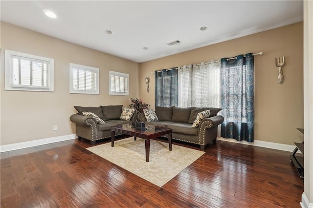 living room with recessed lighting, visible vents, baseboards, and hardwood / wood-style flooring