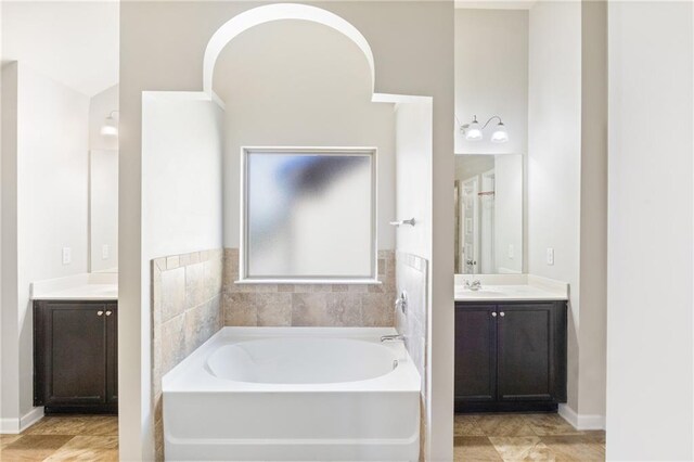 bathroom with vanity, tile patterned floors, and a bathtub