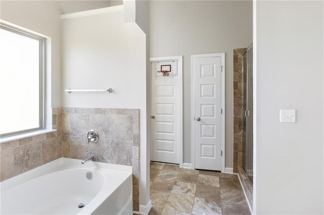 bathroom with separate shower and tub