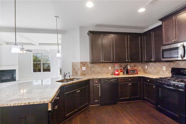 kitchen featuring dark hardwood / wood-style flooring, tasteful backsplash, sink, black appliances, and decorative light fixtures