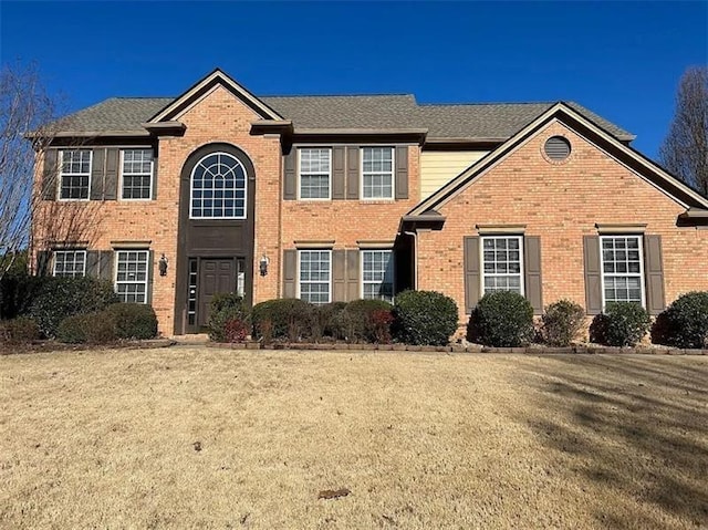 1085 Blackwood Ct, Suwanee, GA 30024 - view of front facade with brick siding and a front yard