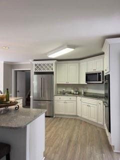 1200 Larson Ln SW, Marietta, GA 30064 - kitchen with stainless steel appliances, light wood-type flooring, and dark stone countertops