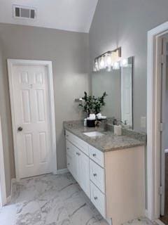 1200 Larson Ln SW, Marietta, GA 30064 - bathroom featuring vaulted ceiling, marble finish flooring, and vanity