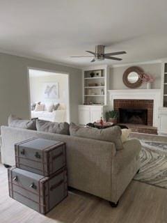 1200 Larson Ln SW, Marietta, GA 30064 - living area with ceiling fan, a brick fireplace, wood finished floors, and built in shelves